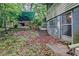Backyard showing covered structure, steps to back door and aged painted exterior of home at 1774 Willis Mill Rd, Atlanta, GA 30311