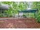 Exterior view of home showing covered structure in backyard with mature trees and landscaping at 1774 Willis Mill Rd, Atlanta, GA 30311
