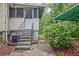 View of home's exterior featuring covered structure, landscaping, walkway and entry door with steps at 1774 Willis Mill Rd, Atlanta, GA 30311