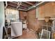 Unfinished basement laundry area featuring washer, window and exposed utilities at 1774 Willis Mill Rd, Atlanta, GA 30311