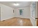 Spacious bedroom boasts hardwood floors, a window and a wooden door at 1774 Willis Mill Rd, Atlanta, GA 30311