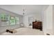 Well-lit bedroom with three windows, an open doorway and light-colored carpet at 1774 Willis Mill Rd, Atlanta, GA 30311