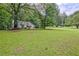 Traditional one-story house with a wide lawn and mature trees in a serene setting at 1774 Willis Mill Rd, Atlanta, GA 30311
