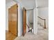 Hallway leads to a basement staircase with painted white walls and wood trim at 1774 Willis Mill Rd, Atlanta, GA 30311