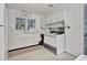 Functional kitchen features white cabinets, a window over the sink and ample counter space at 1774 Willis Mill Rd, Atlanta, GA 30311