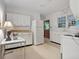 Functional kitchen features white cabinets, a window over the sink and ample counter space at 1774 Willis Mill Rd, Atlanta, GA 30311