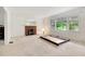 Bright living room with fireplace, large windows and views of lush greenery, ready for updates at 1774 Willis Mill Rd, Atlanta, GA 30311