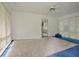 Enclosed sunroom with a ceiling fan, many windows, and blue carpet with a tan rug at 1774 Willis Mill Rd, Atlanta, GA 30311