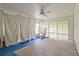 Sunroom with beadboard ceiling, fan, many windows, and blue carpet with a tan rug at 1774 Willis Mill Rd, Atlanta, GA 30311