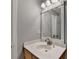 Bathroom features a vanity with a white countertop, a mirror, and ample lighting at 2612 Back Creek Chase, Dacula, GA 30019