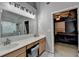 This bathroom has a double vanity and a shower with marble surround at 2612 Back Creek Chase, Dacula, GA 30019