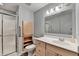 Bathroom featuring a shower, vanity with a white countertop, and a large mirror at 2612 Back Creek Chase, Dacula, GA 30019