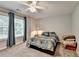 Bright bedroom with carpet, a ceiling fan, and natural light from the window at 2612 Back Creek Chase, Dacula, GA 30019