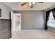 Bedroom featuring soft carpet, neutral paint, natural light from window, and access to the hallway at 2612 Back Creek Chase, Dacula, GA 30019