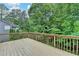 Wooden deck overlooking a lush, green backyard, providing an ideal space for outdoor relaxation and entertaining at 2612 Back Creek Chase, Dacula, GA 30019