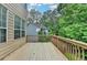 Elevated wooden deck offering views of the surrounding greenery and neighboring houses, ideal for outdoor enjoyment at 2612 Back Creek Chase, Dacula, GA 30019