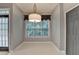 Bright breakfast area with a large window and stylish lighting fixture at 2612 Back Creek Chase, Dacula, GA 30019