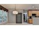 Dining area with a large window, modern lighting, and neutral color scheme at 2612 Back Creek Chase, Dacula, GA 30019