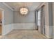 Neutral dining room with modern chandelier, chair rail, and natural lighting at 2612 Back Creek Chase, Dacula, GA 30019