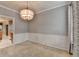 Neutral dining room with modern chandelier, chair rail, and space for entertaining at 2612 Back Creek Chase, Dacula, GA 30019