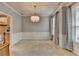 Elegant dining room featuring chair rail molding, large windows with curtains, and a stylish chandelier at 2612 Back Creek Chase, Dacula, GA 30019