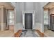 Welcoming foyer showcasing beautiful hardwood floors and natural light from the windows on either side at 2612 Back Creek Chase, Dacula, GA 30019