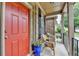 Front porch offers seating with a colorful garden leading to a striking red front door at 2612 Back Creek Chase, Dacula, GA 30019