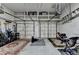 Spacious garage with two overhead doors, featuring overhead storage racks and room for multiple vehicles at 2612 Back Creek Chase, Dacula, GA 30019