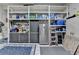 Well-organized garage area with storage shelves, cabinets, and a refrigerator, providing functional space at 2612 Back Creek Chase, Dacula, GA 30019
