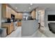 Open kitchen layout, granite countertops, stainless steel refrigerator and appliances, and tile flooring at 2612 Back Creek Chase, Dacula, GA 30019