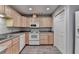 Cozy kitchen featuring wood cabinets and modern appliances at 2612 Back Creek Chase, Dacula, GA 30019