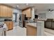 Open kitchen with stainless steel appliances, tile floors, and a breakfast bar overlooking the living room at 2612 Back Creek Chase, Dacula, GA 30019