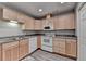 Bright kitchen featuring wood cabinets and modern white appliances at 2612 Back Creek Chase, Dacula, GA 30019