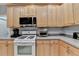 Kitchen featuring stainless steel appliances, light wood cabinets, and granite countertops at 2612 Back Creek Chase, Dacula, GA 30019