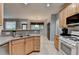Kitchen features stainless steel appliances, wood cabinets, and connects to an eat-in area with natural light at 2612 Back Creek Chase, Dacula, GA 30019