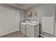 Bright laundry room with a washer, dryer, and double door closet at 2612 Back Creek Chase, Dacula, GA 30019