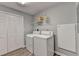 The laundry room includes a washer, a dryer, and a shelf at 2612 Back Creek Chase, Dacula, GA 30019