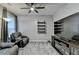 Comfortable living room featuring a ceiling fan, chairs, and a wall-mounted shelving unit at 2612 Back Creek Chase, Dacula, GA 30019