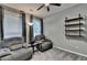 Comfortable living room featuring a ceiling fan, chairs, and a wall-mounted shelving unit at 2612 Back Creek Chase, Dacula, GA 30019