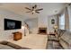 Bright living room with a fireplace, ceiling fan, and carpet floors at 2612 Back Creek Chase, Dacula, GA 30019