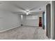 Open living room features gray carpet, natural light, and neutral paint at 2612 Back Creek Chase, Dacula, GA 30019