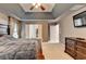 This main bedroom has neutral walls, trey ceiling, and a TV mounted on the wall at 2612 Back Creek Chase, Dacula, GA 30019