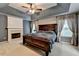 Spacious main bedroom with a stone fireplace and a ceiling fan at 2612 Back Creek Chase, Dacula, GA 30019