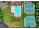 Aerial view of community pool and tennis courts surrounded by lush greenery and landscaping at 2612 Back Creek Chase, Dacula, GA 30019