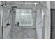 This shower has a glass door and a marble surround at 2612 Back Creek Chase, Dacula, GA 30019