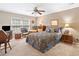 Bedroom with a ceiling fan, patterned bedding, and comfortable seating area at 237 Lamplighter Ln, Marietta, GA 30067