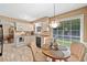 Eat-in kitchen features a garden window, cream cabinets, tile floor, and a table with seating for three at 237 Lamplighter Ln, Marietta, GA 30067