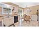 Bright eat-in kitchen featuring a large window, cream cabinets, stone countertops, and updated appliances at 237 Lamplighter Ln, Marietta, GA 30067