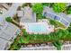 Overhead view of a community pool surrounded by lush landscaping and lounge chairs at 4588 Pine Se St, Smyrna, GA 30080