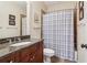 Well-maintained bathroom with granite countertop vanity and a shower with a pattern curtain at 4588 Pine Se St, Smyrna, GA 30080